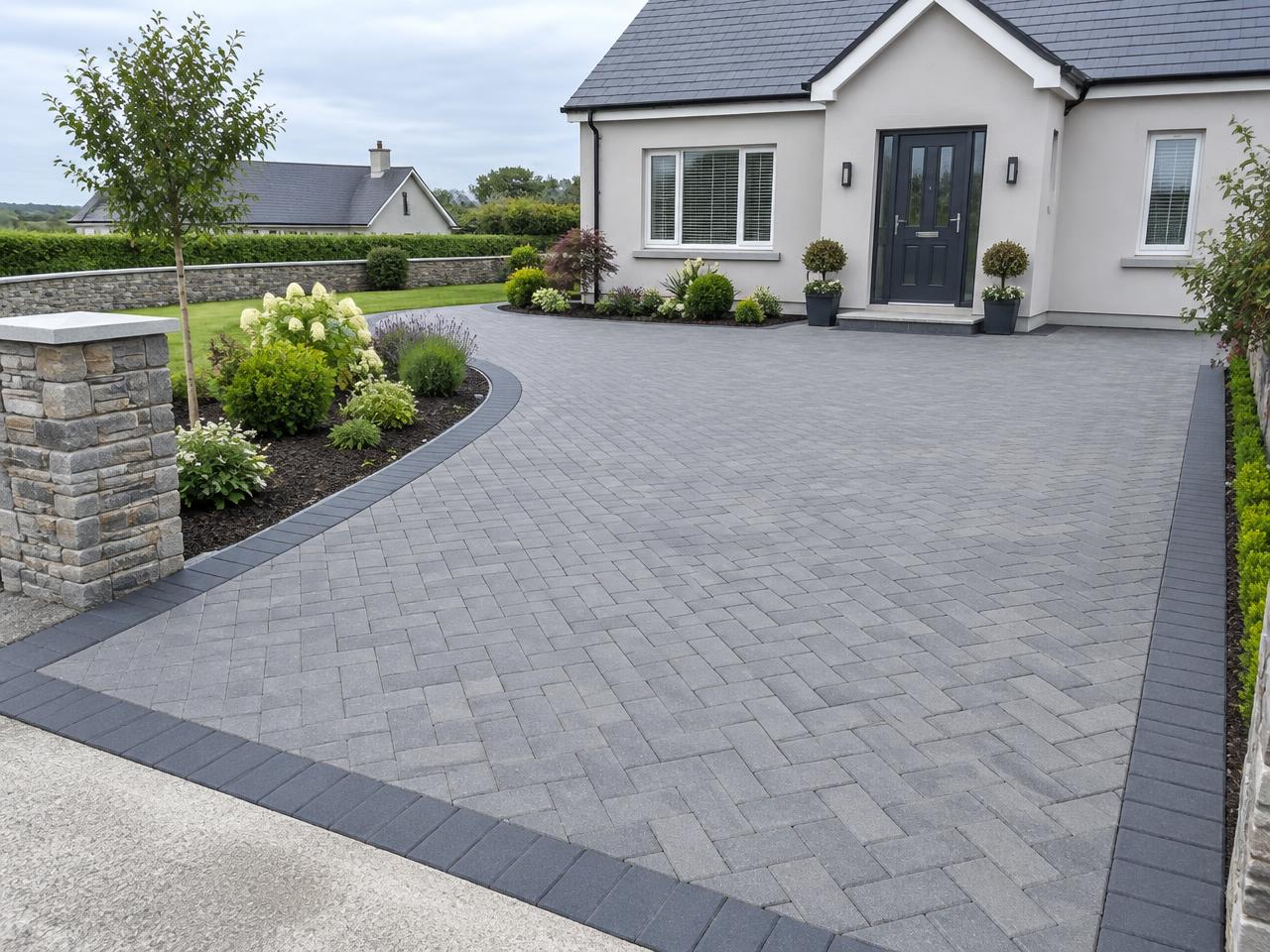 Grey block-paved driveway with charcoal border edging